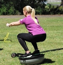 Group PT outdoors bosu squat